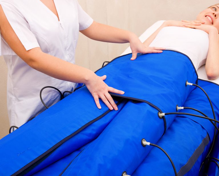 legs pressotherapy machine on woman in beauty center